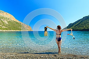 Woman with flippers snorkeling tube on beach