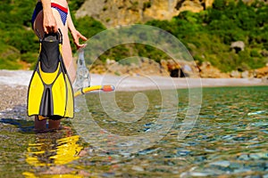 Woman with flippers snorkeling tube on beach