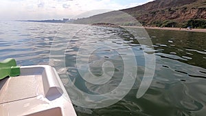 Woman floating on catamaran. Person pedaling with feet and swimming on catamaran