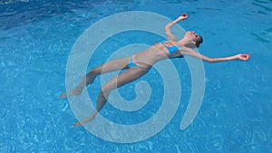 Woman floating limp in water