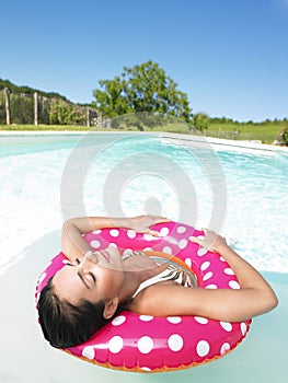 Woman Floating in Pool With Eyes Closed