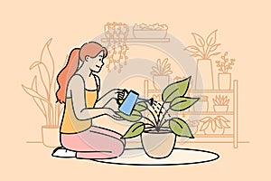 Woman florist grows houseplants to decorate own apartment, waters flower while sitting on floor