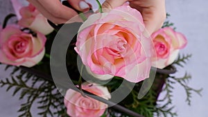 Woman florist making flowers bouquet Flowers arrangement in box created by florist wedding gift. Rose roses bouquet