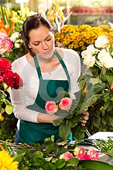 Woman florist preparing bouquet flowers shop retail