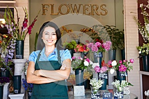 Woman florist standing outside shop photo