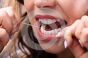 Woman Flossing Her Teeth