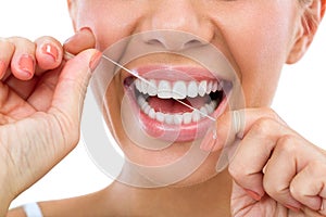 Woman flossing her teeth