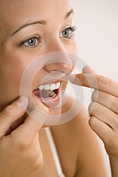 Woman Flossing Teeth