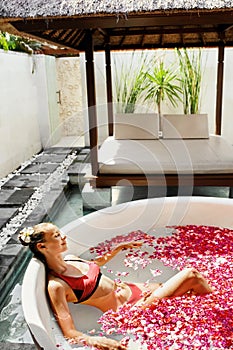 Woman In Flower Bath At Day Spa Salon
