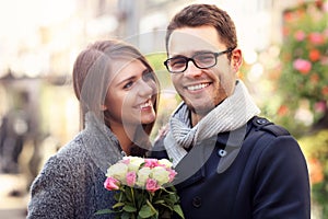 Woman with flowers giving hug to her man