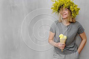 Woman with  flowers on the head holding ice cream cone with sprinkles