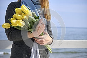 Woman with flowers near the sea shore