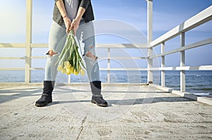 Woman with flowers near the sea shore