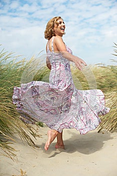 Woman with flowing dress at the beach