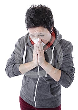 Woman with the flu blowing her nose