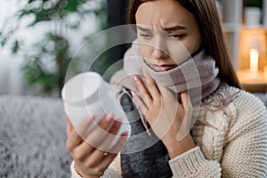 Woman with flu holding medication