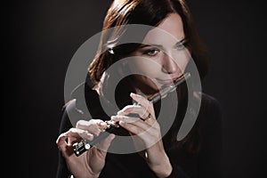 Woman with flute piccolo flutist photo