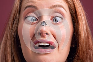 Woman with a fly on her nose