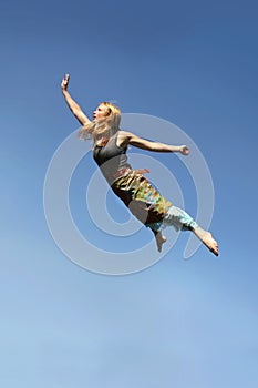 Woman Flying Through Blue Sky