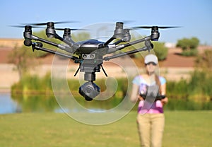 Woman Flying High-Tech Camera Drone (Large File) photo