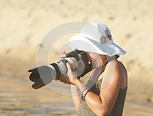 Woman focus with camera in sun
