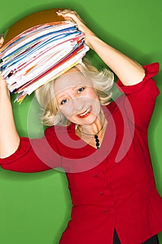 Woman with folders over head