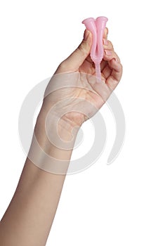 Woman folding pink menstrual cup on white background, closeup