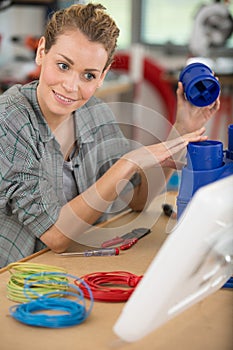 woman following instructions for assembly electrical unit