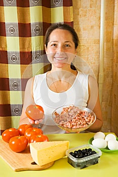Woman with food products for farci tomato