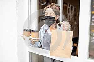 Woman with food to take away in the shop window