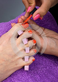 Woman foot in nail polishing