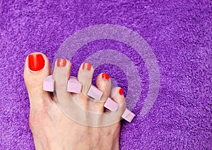 Woman foot nail polishing in salon