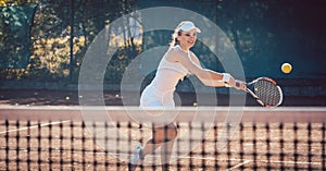 Woman forcefully playing tennis