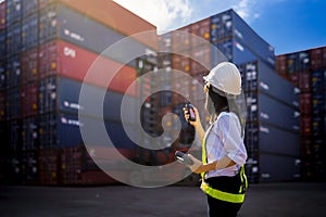 Woman Foreman control loading Containers box