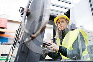 Woman forklift truck driver in an industrial area.