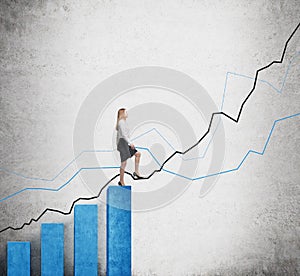A woman in formal clothes is going up over blue bar charts as stairs and she is going to continue her way by using a growing blue