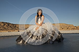 Woman formal dress ice sit smile blue sky