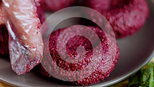 The woman forms bubbles from pkhali. Pkhali traditional Georgian food. Beetroot is used for the purple color. Walnut is