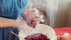 The woman forms bubbles from pkhali. Pkhali traditional Georgian food. Beetroot is used for the purple color. Walnut is