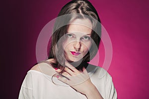 Woman freckle portrait on color background red and pink