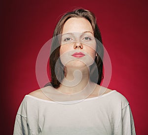 Woman freckle portrait on color background red and pink