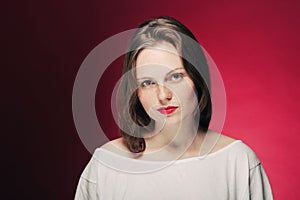 Woman freckle portrait on color background red and pink