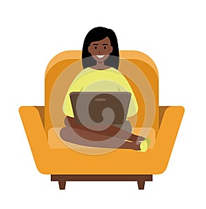Woman freelancer African American with a laptop sitting on a sofa