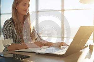 Woman freelancer female hands with pen writing on notebook at home or office