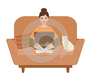 Woman freelancer with a laptop sitting on a sofa