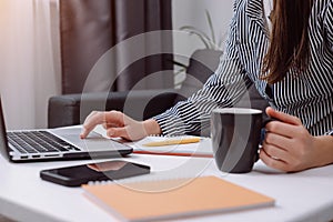 Woman freelancer working on laptop at home-office. Startup concept. Close up of female hands working computer typing on keyboard