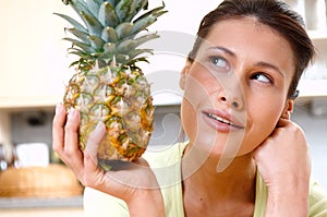 Woman with fresh pineapple