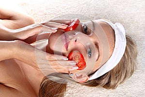 Woman with fresh tomatoes mask