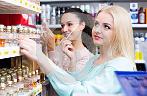 Woman friends buying perfume