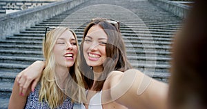 Woman friends, city selfie and hug by stairs on travel, exploring or vacation in summer for bonding together. Best